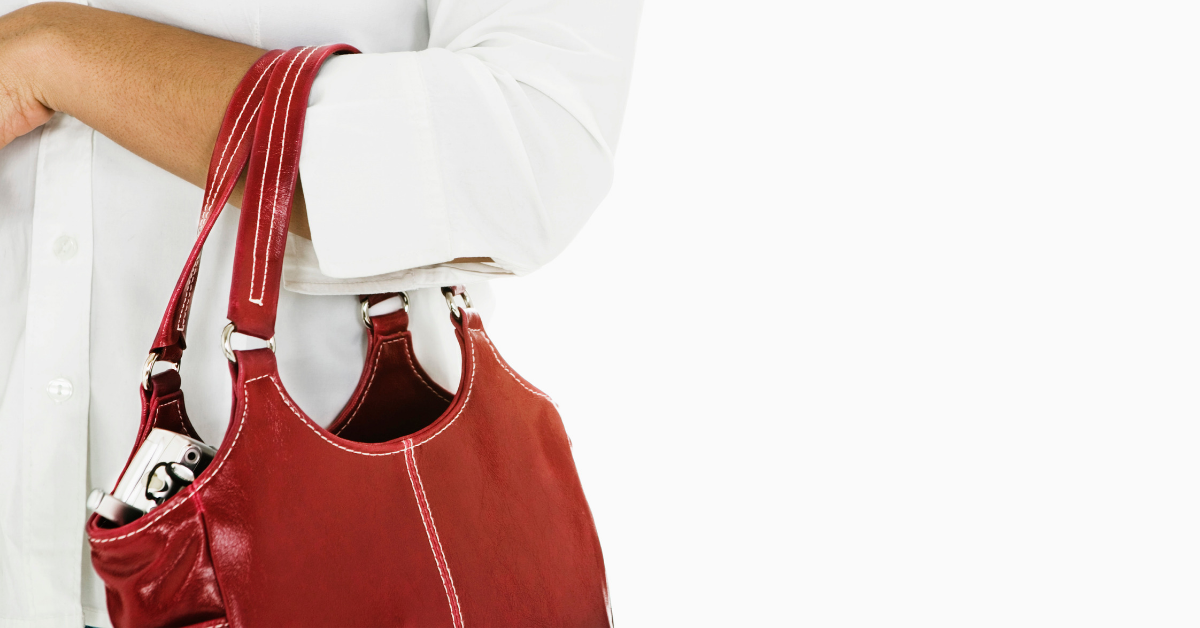 A red purse around a woman's arm